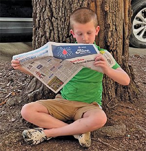 Taking A Break To Read The Shelby Shopper