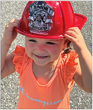 Avera Harris appears to be wanting to become a junior fire fighter. 