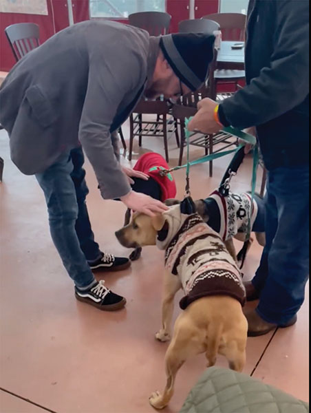 Chris Kratzer takes a moment to bless Corey Steele's dogs, Conan, Charlie, and Annie.