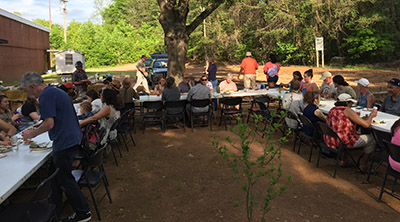 Gathering for an Earth Day potluck at Holly Oak Park community garden