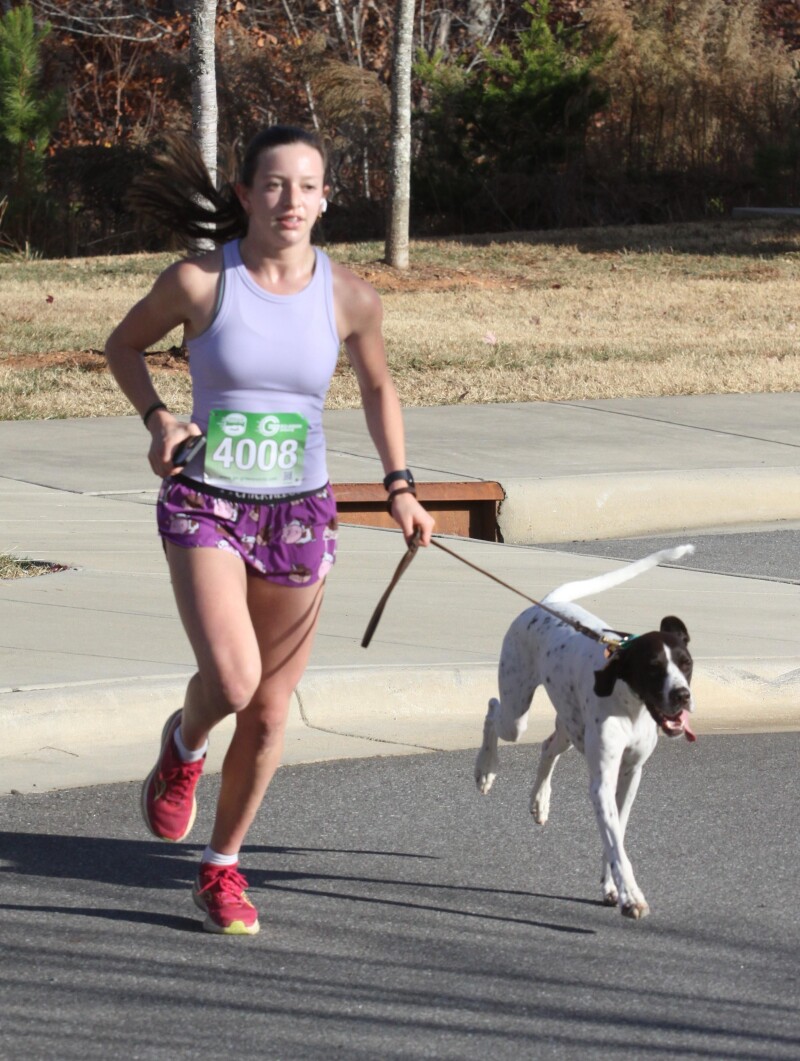 Stella Friedman ran with her dog Bergen at the Hounds at Hanna 5K that was held at Hanna Park in Shelby.