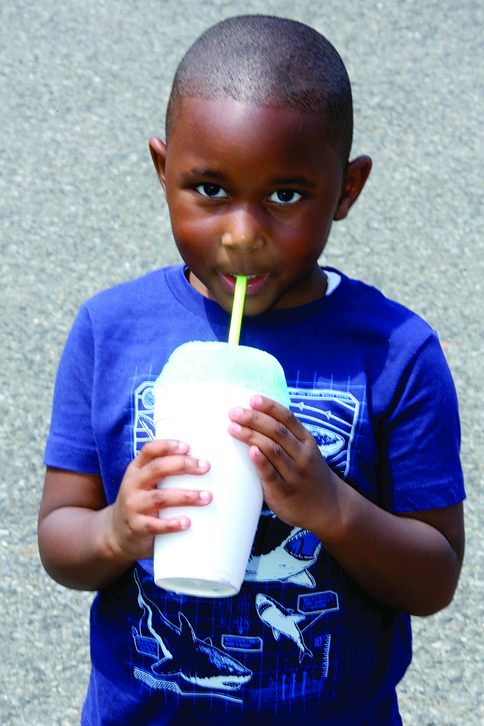 Carlos Thompson Jr. enjoys a Snow Cone at the National Kids to Park and Dog Rescue Day with Clifford's Army Rescue Extravanganza on May 21st.