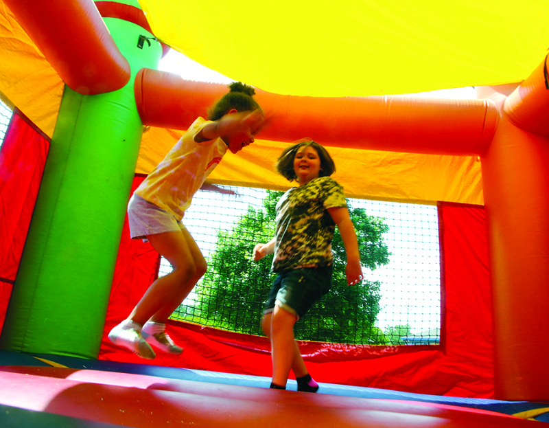 Ella Ramsey and Jessi Hunt enjoy the bouncy house at the National Kids to Park and Dog Rescue Day at the Shelby City Park.