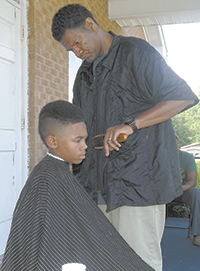 Keith Rhodes gives back-to-school haircuts...
