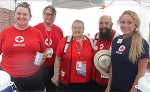 Red Cross Workers Hand Out Water to Fans