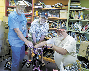 Volunteers assemble bicycles...