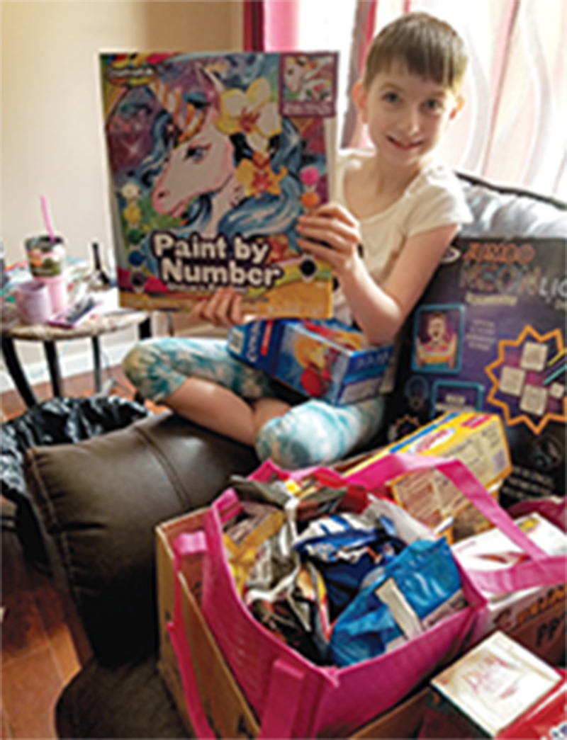 Hospice patient's granddaughter shows paint set.