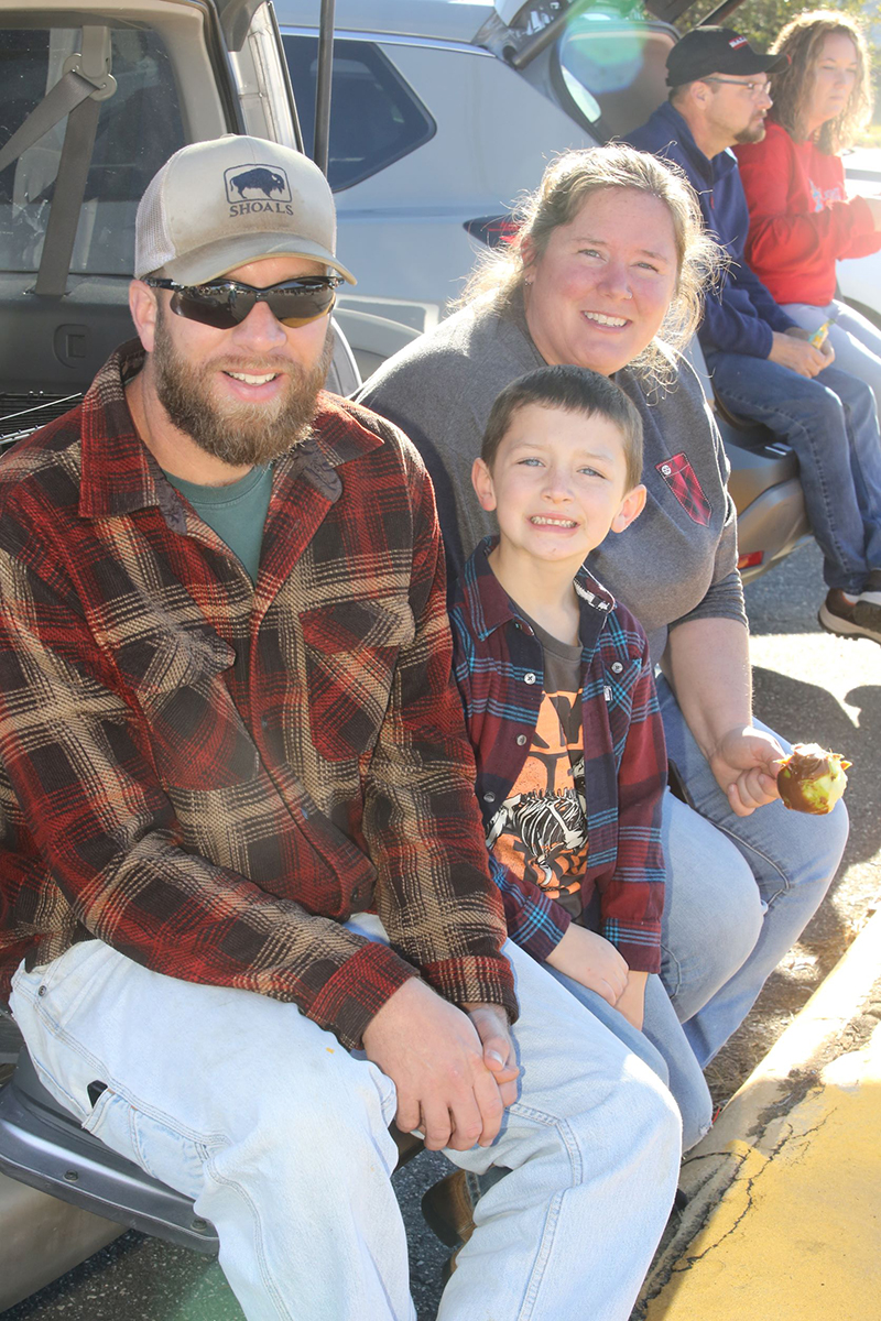 Brian Willis, Mac Willis and Sara Willis watch the Casar Christmas Parade.