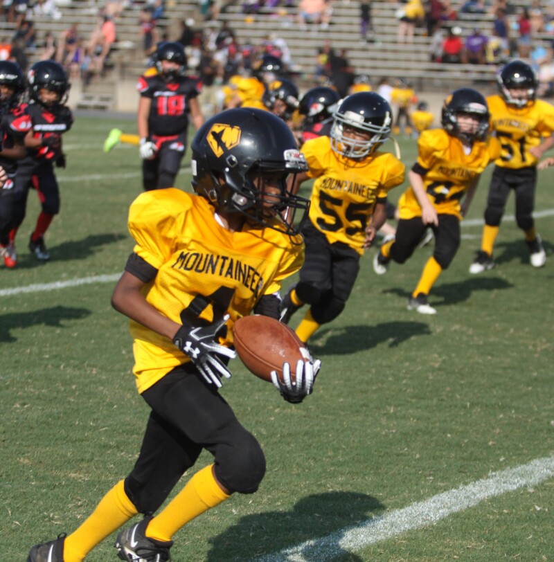 Kings Mountain's Jayshaun Moore runs the ball during the game with Springmore at the Cleveland County Football League Kick-Off Jamboree. 
