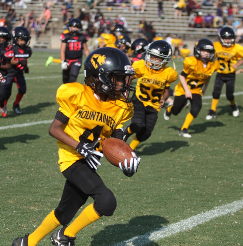 Kings Mountain's Jayshaun Moore runs the ball during the game with Springmore at the Cleveland County Football League Kick-Off Jamboree. 