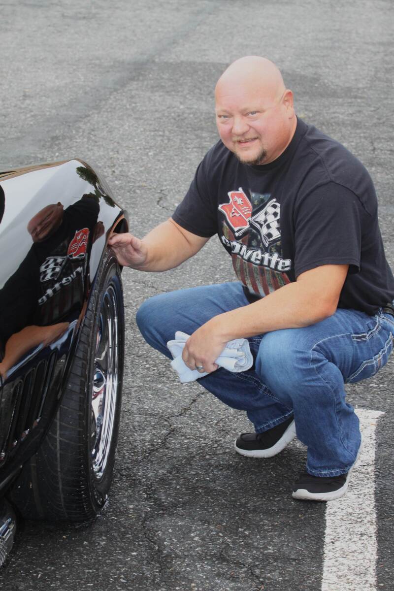 Chad Blanton is pictureed detailing his 1968 Chevrolet Corvette at the Crest Middle School Car Show & Craft Fair. 
