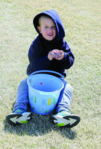 Wilkes Davis opens an egg after the Easter Egg Hunt at Hanna Park on Saturday 9, 2022. 