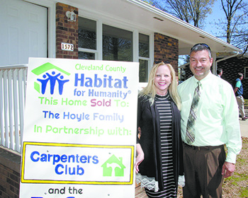 Keith and Michelle Hoyle stand in front of their Habitat for Humanity of Cleveland County home.