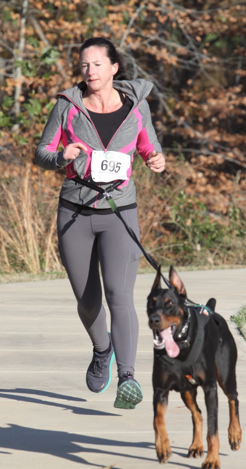 Nicole Hass runs with her dog at the Hounds at Hanna 5K race on Saturday, November 19th.  