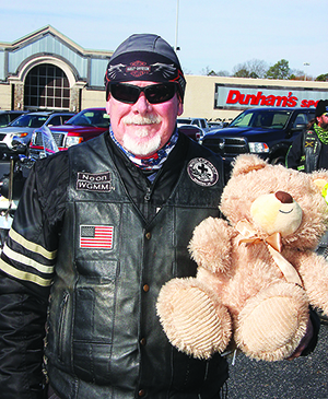 Walt Dyer, with the Wheels of Gracer, has a toy for a child for the 32nd Annual Windjammers Toy Run. 