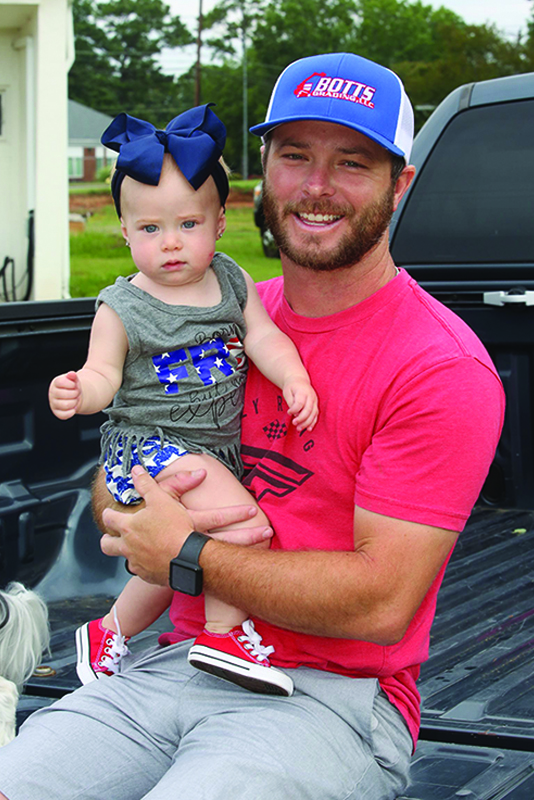 Lucas Towery with his daughter Rylee waiting for the Lattimore July 4th parade to start on Monday. 