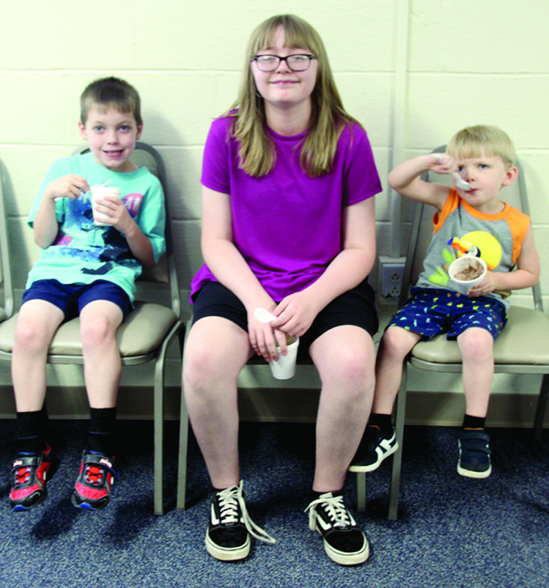 Landon Butler, Abigail Tessneer and William Maldonado eat ice cream at the Preregistration Day at Lily Memorial Baptist Church