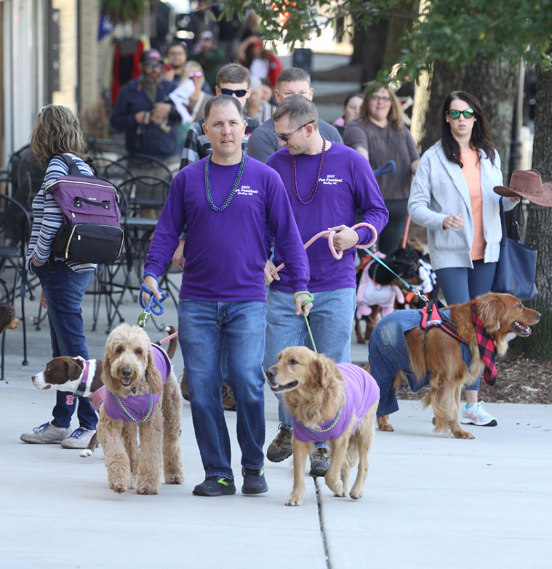Fred Harrill owner of RollOver Pets in Uptown Shelby is pictured with his family's dogs Jack and Blue as they lead the Pet Parade at the Mush, Music a