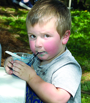 C.J. Bowen sips on a blue slushie at the 25th Foothills Merry Go Round Festival.  