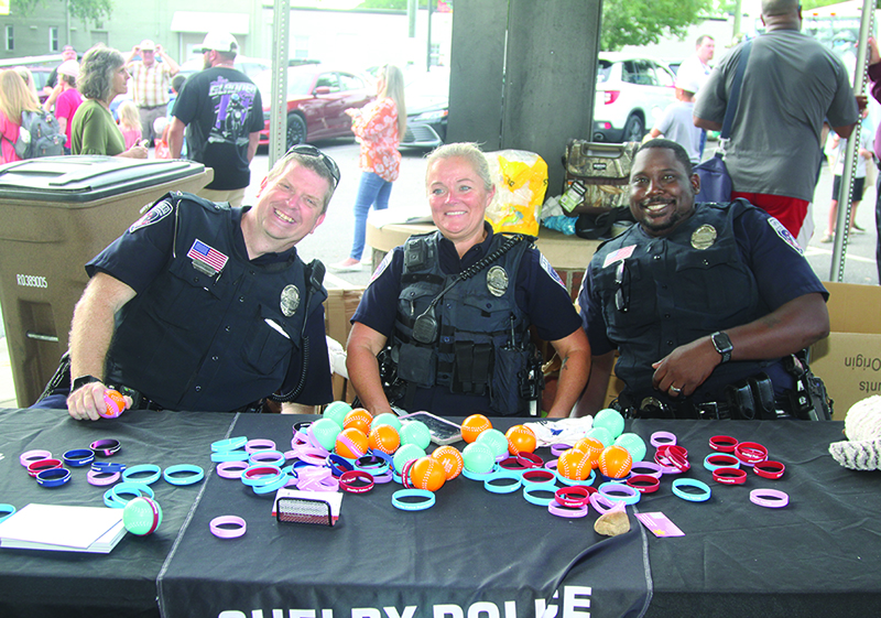 Shelby Police officers Wampler, Scell, and Hill greet members of the community at the Shelby Police Department's National Night Out