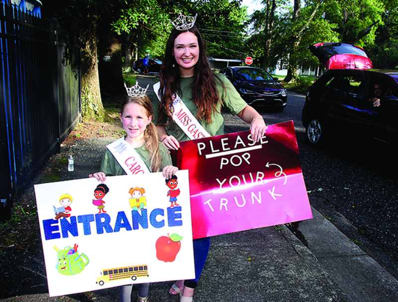 Ember Lynn Cole Miss Gastonia Carolina Princess and Alexandria Foy Miss Gaston County Outstanding Teen greet cars of people.