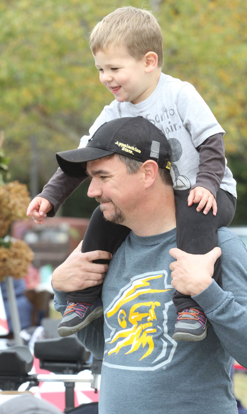 Tyler and his father Matt Love visit vendors and admired the vehicles at the October Fest Vendor and Car Show. The annual event was held at the Neal S