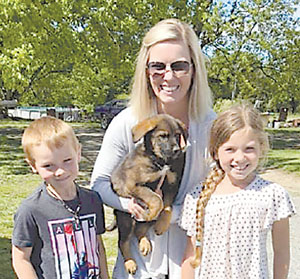 Family adopts puppy from C.A.R.E.