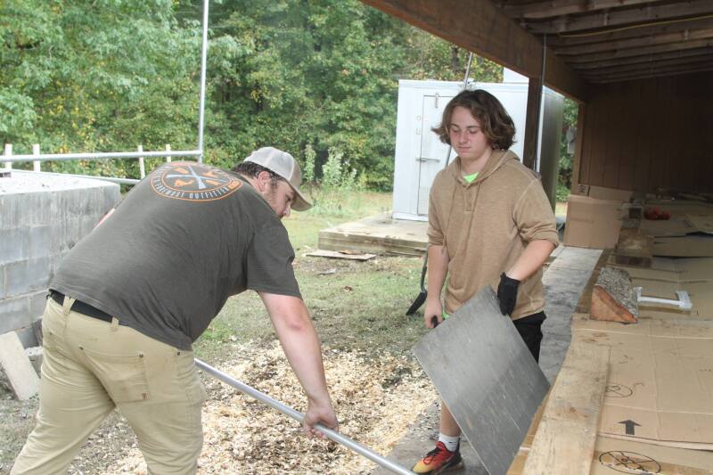 Brandon and Luke Ruppe make sure the coals were hot during the Sulphur Springs Methodist Church Annual BBQ